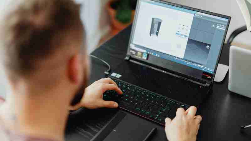 Man using laptop and tablet for 3D design, showcasing modern digital work environment., tags: arte - pexel